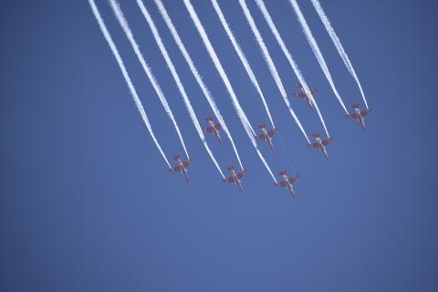 The Indian Air Force's aerobatic team Suryakiran performs maneuvers during Aero India 2023.